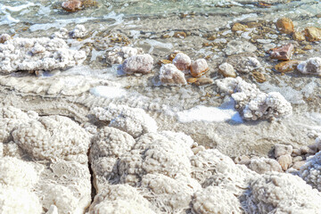 Close up of salt background. Natural salt. Dead Sea salt mineral natural formations. Salt crystals from Dead sea. View of Dead Sea coastline. Texture of Dead sea. Salty seashore rocks