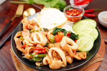 Stir-fried squid with basil and fried egg with cooked rice Popular Thai food