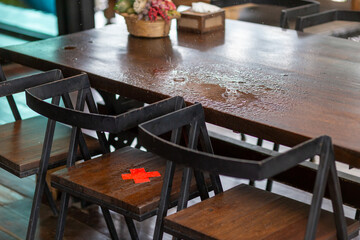 selective focus wooden table in a restaurant maintain the distance between coronavirus control,...