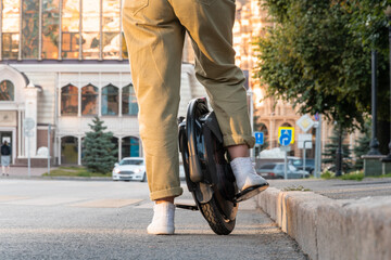 a young woman on electric unicycle (EUC) © Alex Images