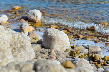 Close up of salt background. Natural salt. Dead Sea salt mineral natural formations. Salt crystals from Dead sea. View of Dead Sea coastline. Texture of Dead sea. Salty seashore rocks