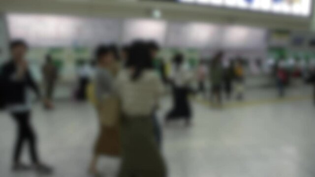 Blurred defocused an Japanese people buying ticket at metro station in Tokyo. Tourist traveling on train in Japan, Asia. Subway underground fast transportation and Asian commuters