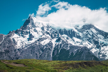 Snowy mountain tops with clouds in Chilean Patagonia