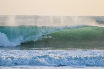 Surfer in a perfect barrel wave.