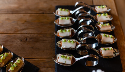 Tasty appetizers in spoons on plate