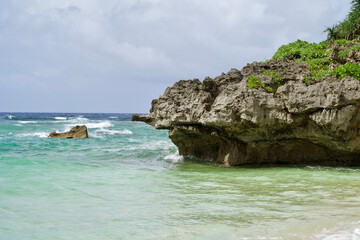 Fototapeta na wymiar The cape and blue water at the beach in Okinawa.