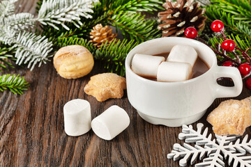 Hot chocolate or cocoa drink in a white cup, sweet homemade cookies