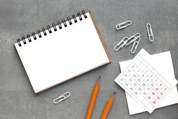 Notepad, white sticker and pensil on the desk. Mock up in copy space office background. It is important not to forget the note