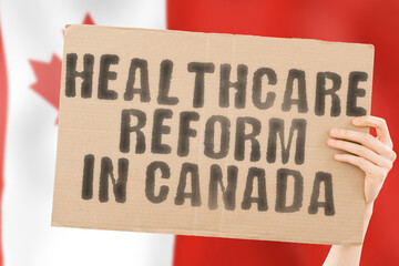 The phrase " Healthcare reform in Canada " on a banner in men's hand with blurred Canadian flag on the background. Nation. Crisis. Problem. Medical help. Reformation. Clinical
