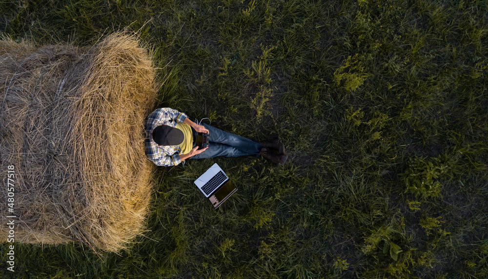 Aufkleber Farmer with laptop on the field. Drone point of view. Smart farming and agriculture digitalization	