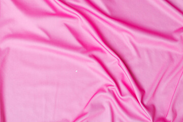Fototapeta na wymiar Closeup rippled soft pink fabric texture background