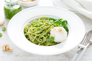 Pasta with basil pesto, cashew nuts and soft cream cheese