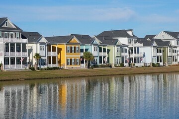 Brightly Colored Houses Reflected in a Pond in a Suburban Neighborhood