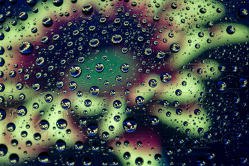 Flowers by drops of water. Blurred background.