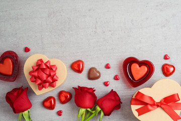 Valentines day concept with heart shapes, chocolates, gift box and rose flowers. Top view background