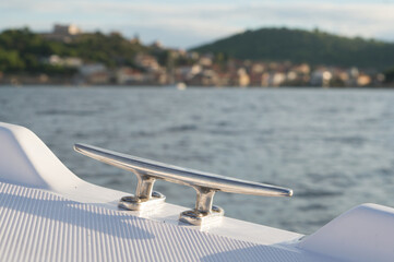 Steel mooring cleat on the small plastic pleasure boat, nautical equipment, Adriatic se, Croatia