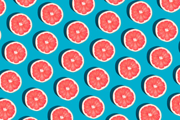 Minimal fruit pattern with grapefruit on blue  background. Creative  summer mood. Healty concept....