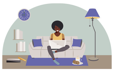 Happy swarthy woman sitting on comfortable gray sofa working with laptop at home during quarantine due to coronavirus. Modern concept of distance learning online. 