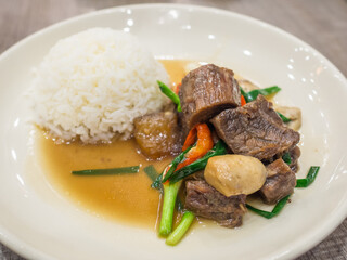 stir beef steam cook with vegetable and rice on a white dish 