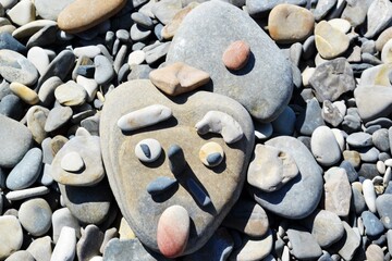 face made of stones on the seashore
