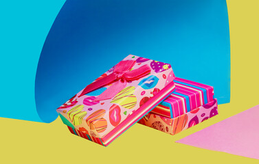 Several multicolored gift boxes on a colored background.Yellow,pink