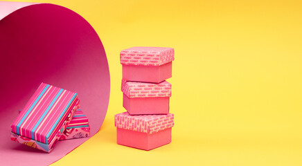 Many multi-colored gift boxes on a colored background, Fashionable