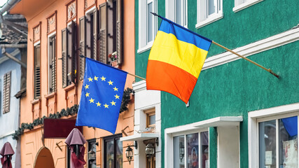 Romanian and European flags on a building in Romania