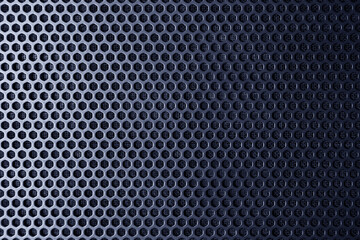 Industrial background. Metallic surface with regular round holes (abstract, texture)