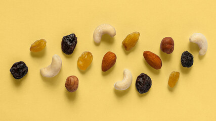 Laid out on a beige background nuts  (Cashews, almonds, hazelnuts) and raisins