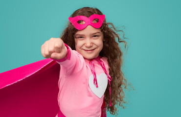 Strong girl in superhero costume and with clenched fist - obrazy, fototapety, plakaty