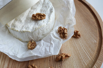 camembert cheese with honey and nuts on a wooden background 