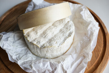 camembert cheese with honey and nuts on a wooden background 