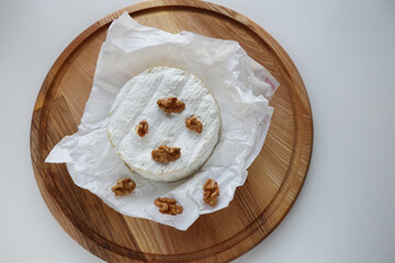 camembert cheese with honey and nuts on a wooden background 