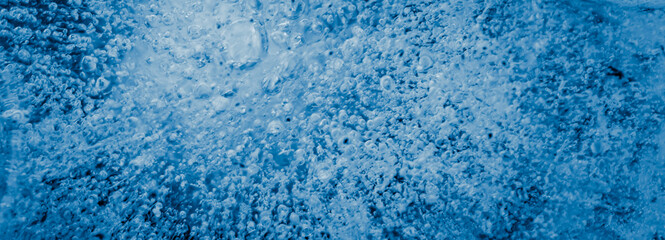 Fototapeta na wymiar frozen water drops on a blue background