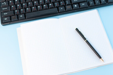 A notebook with black keyboard. Work at home. Work in internet. Online learning. Work with computer. Simple composition.