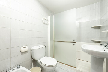 Naklejka na ściany i meble White bathroom with shower and glass partition, white porcelain sink and toilet