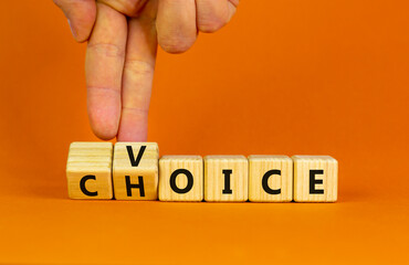 Voice and choice symbol. Businessman turns wooden cubes and changes the concept word choice to voice. Beautiful orange table, orange background, copy space. Business and voice and choice concept.