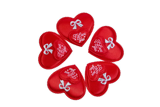 A group of decorative red hearts with the inscription I love you arranged in a circle on a white background