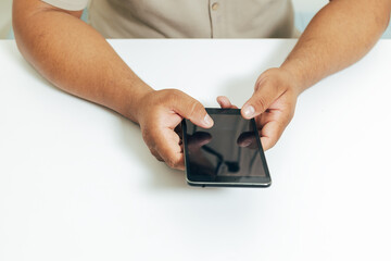 person checking the mobile on a table