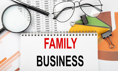 Text FAMILY BUSINESS on white paper notebook on the diagram. Business concept