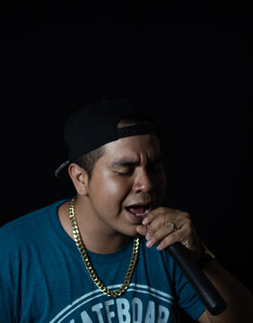 latin urban singer handholding a microphone