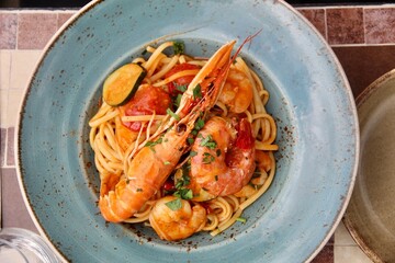 lobster on tomato sauce pasta and vegetables