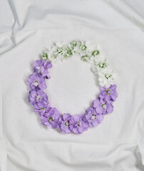 Floral, botanical or valentines day concept. Beautiful purple hydrangea and white flowers circle composition isolated on white cloth. Copy space for text. Spring flowers aesthetics. High quality photo