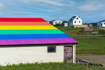 Barn with a rainbow roof supporting equal rights for LGBTQ people community. Westfjords, Iceland - obrazy, fototapety, plakaty
