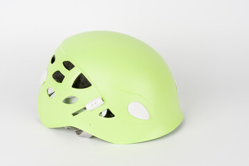 Fototapeta premium New green climbing helmet on white background.