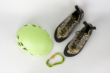 New green climbing helmet and green  HMS carabiner, screw lock snap hook and climbing footwear