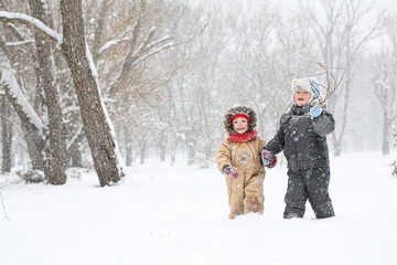 Boy and girl walking in winter park