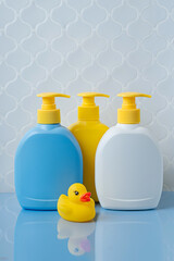 Obraz na płótnie Canvas Soap or shampoo bottles with cute duck in the bathroom. Baby bathing accessories