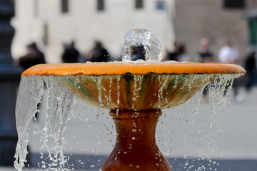 A water fountain in Rome, Italy with bokeh of people in the background