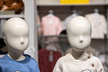 front image of shiny white female mannequin doll with a male mannequin figure in the back, front...